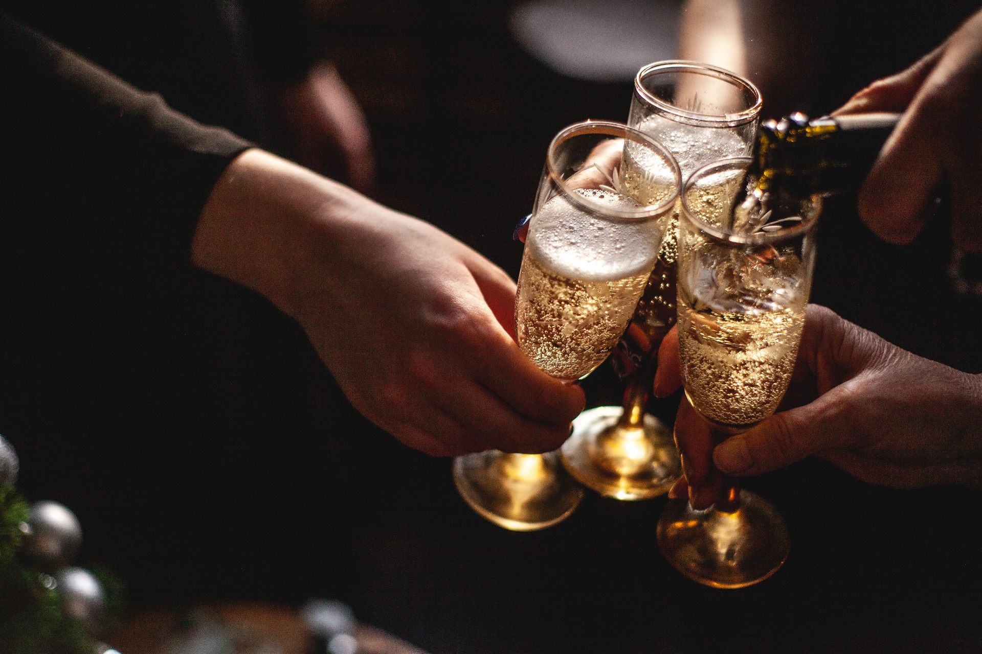 Champagne poured into three glasses